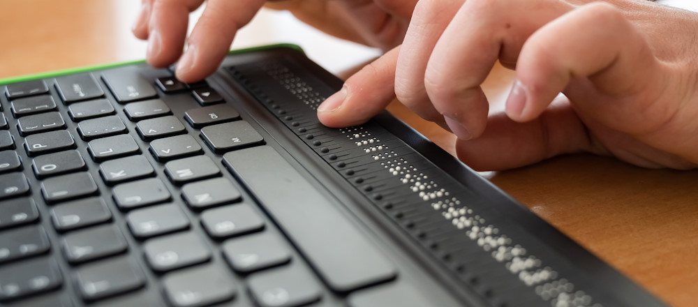 student using braille keyboard