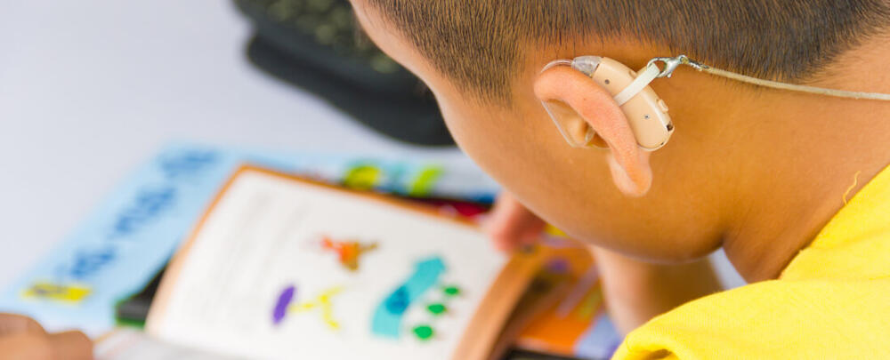 Child with a hearing aid